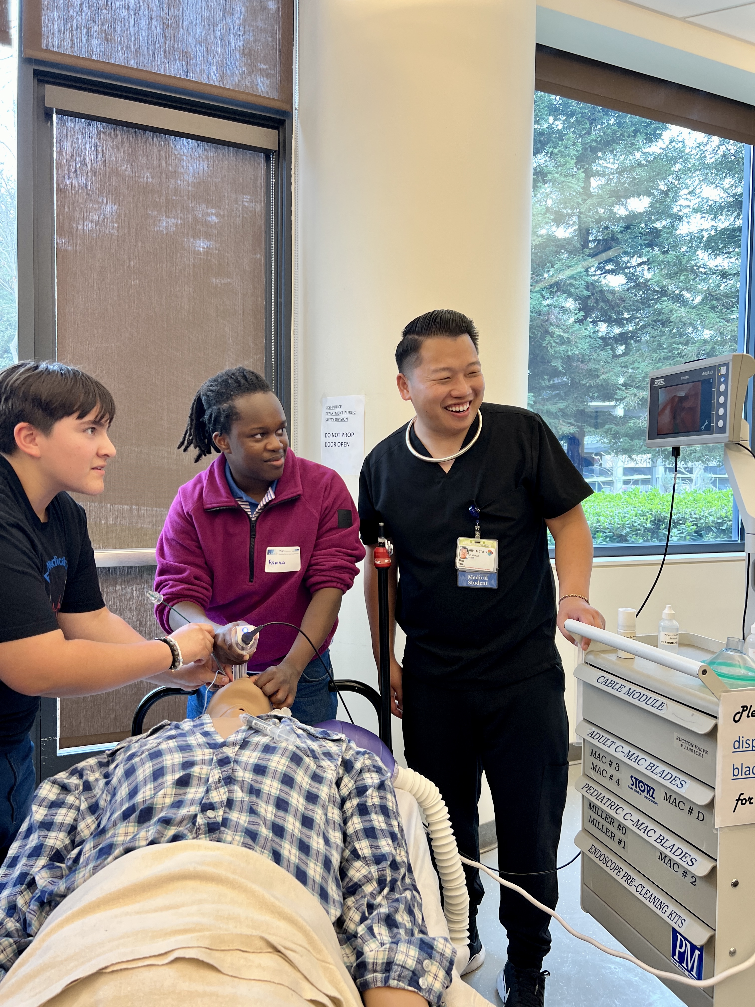 Aspiring doctors practicing on training dummies.